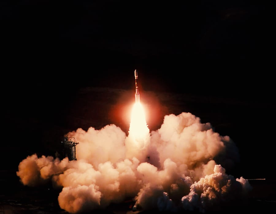 Launch of the spaceship from the spaceport at night. Flight of space shuttle in clouds of smoke. Some elements of this image are furnished by NASA